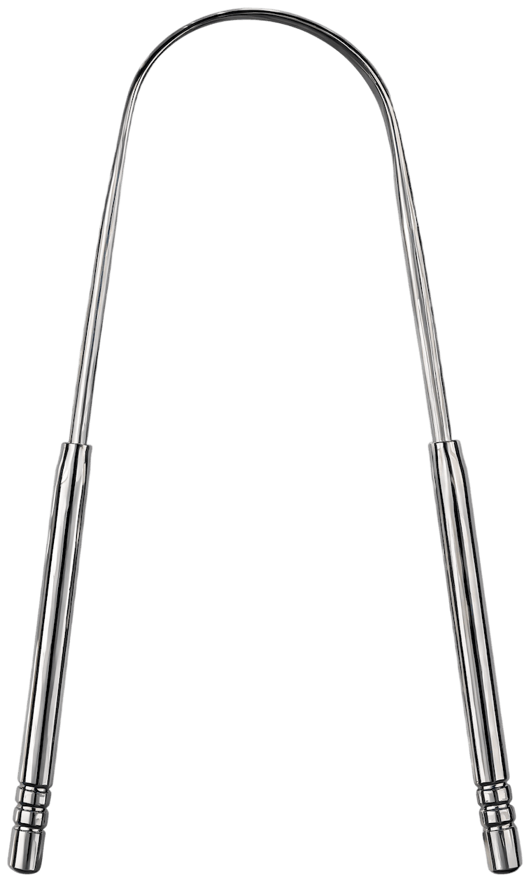 A polished stainless-steel tongue scraper on a warm linen surface, soft daylight.
